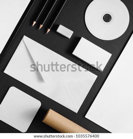 Photo of blank stationery set on black paper background. Corporate ID mock up for placing your design. Flat lay.