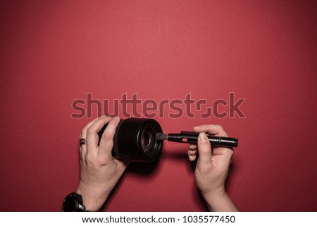 man is cleaning a lense