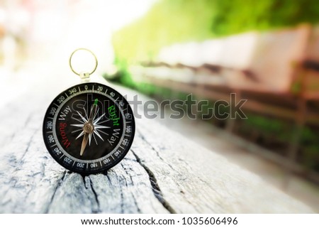 Compass with Right Way and Wrong Way words on old wood table in the park, Find the Right Way Concept