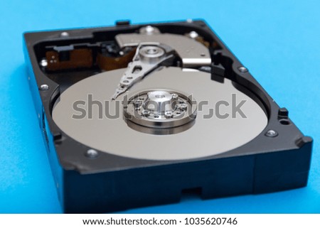 disassembled hard disk close-up on a blue background