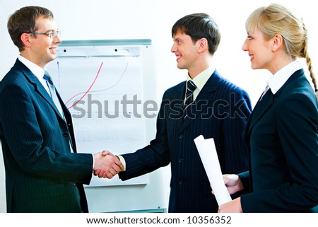 Business people agreed to terms of a treaty by shaking hands