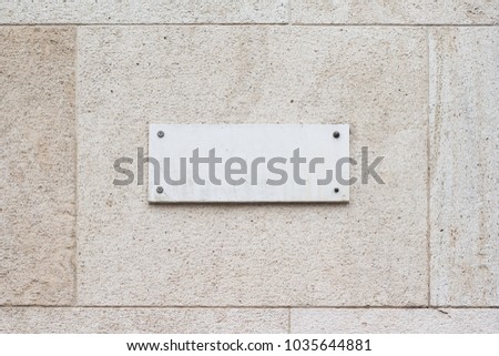 horizontal closeup of square empty marble plaque signboard on a building with classic architecture