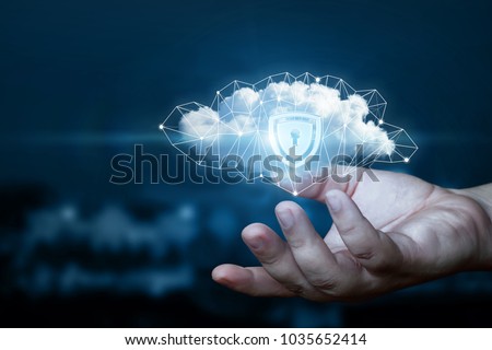 Hand shows a data cloud with a protective shield. The concept of data protection