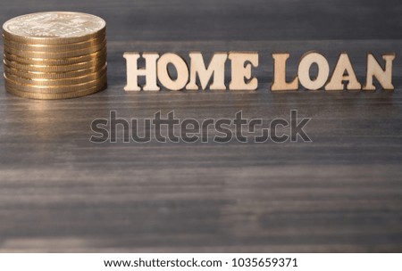 'Home Loan' words with golden coin on dark wooden table top