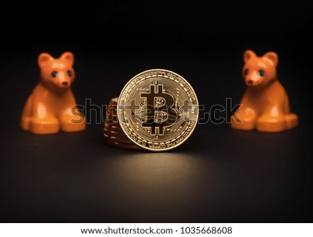 Bitcoin coins with two plastic toy bears - bear cryptocurrency market concept 