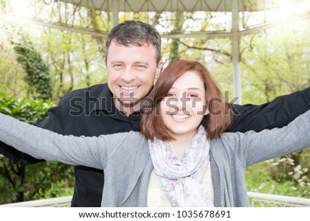 Happy couple taking selfie on the city street park