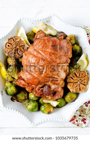 Baked turkey roll with Brussels sprouts, garlic, thyme and lemon
