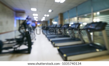 Blurred picture of Fitness Centre. Training apparatus in gym. The abstract blur fitness gym background