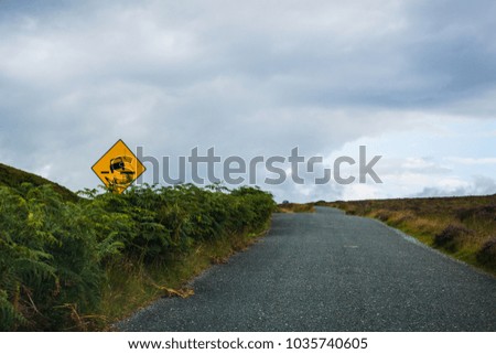 Roadsign "Uneven surface" on country road in Wicklow Mountains, dublin, ireland,	
