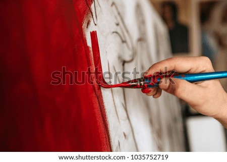  Artist working on a new painting. Close-up