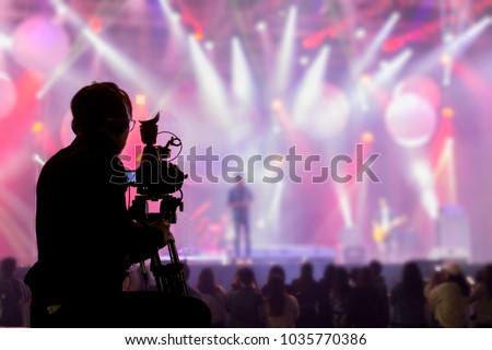 The filmmaker is recording and broadcasting live concerts on camcorders. Professional Video Recording Business Royalty-Free Stock Photo #1035770386