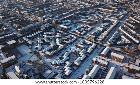 Aerial Drone Image of snowy residential rooftops in South London (Battersea) on a sunny day.