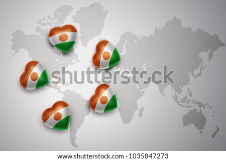 five hearts with national flag of niger on a world map background.concept.3D illustration