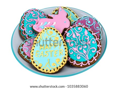 Easter homemade baked gingerbread cookies in the form of eggs with different pattern of icing on plate. Studio Photo