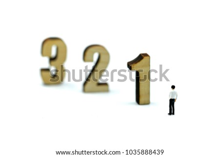 Miniature people : Businessman standing wooden number of 1,2,3