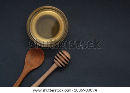 Honey in Glass bowl Isoalted with dipper over dark Background Isolated.flat Lay.