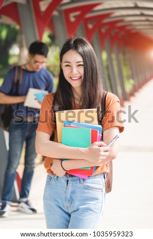 Young woman girl, student hold note book at college and classmates in background