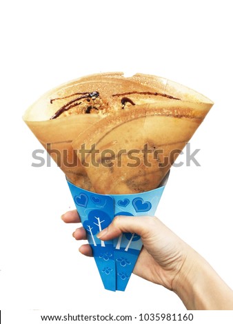 Dessert Chocolate Sauce with Dried Shredded Pork Crepes Pancake,Top View. Woman is Hand Holding Brown Crepe Homemade on White Background Great For Any Use.