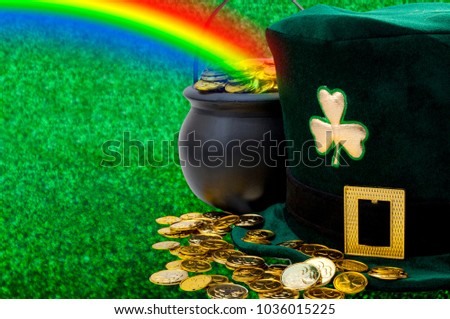 March meme and Happy St patrick's day concept with green funny leprechaun hat with shamrock, pot of gold at the end of the rainbow and scattered golden coins with copy space across the banner