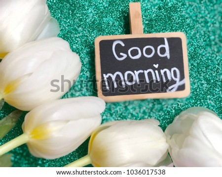 good morning chalkboard with white tulips on grey background