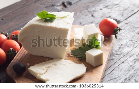 ingredients for greek salad on a wooden board