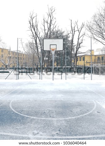 Basket playground covered with snow in Milan