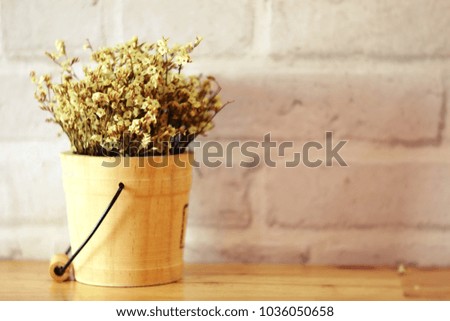 Dried bouquet flowers in wooden flowerpot on important date 