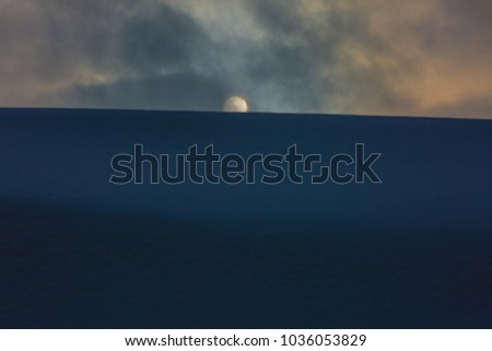 Sunset in Siberian tundra with  a strong wind and clouds covered the sun. Processed picture