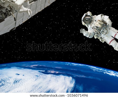 Astronaut waving in space. Earth and spaceship in scene. The elements of this image furnished by NASA.