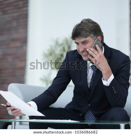 businessman with documents on a blurry office background