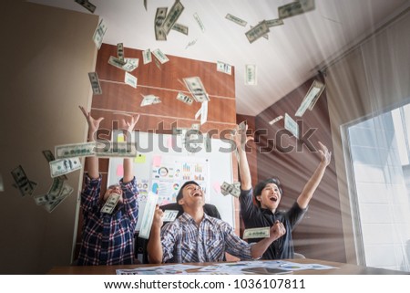 Happy man enjoying the rain of money, Hand receiving money, US dollars, from business man, Rich with success.
