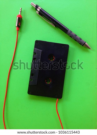 tape converter and a pencil with green background Business
