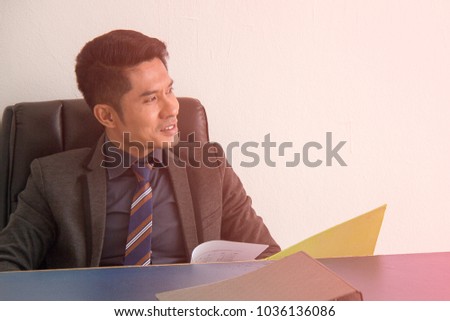 Business man sitting Ideally, planning and monitoring business desk.