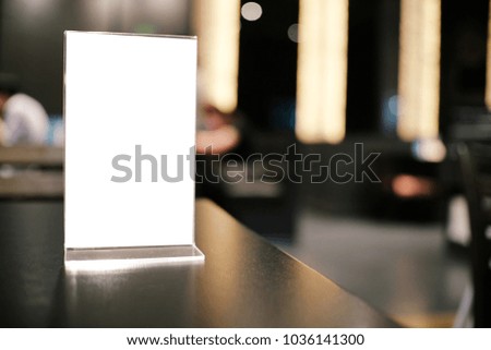 Menu frame standing on wood table in Bar restaurant cafe. space for text marketing promotion