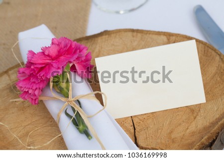Note concepts to write name or a love message. Isolated flower with a sign on a wooden table. Romantic copy space. Valentines day concept. 