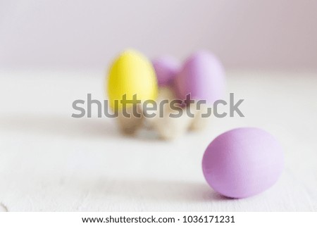 Easter postcard. Violet and yellow Easter eggs on a white vintage background. Copy space.