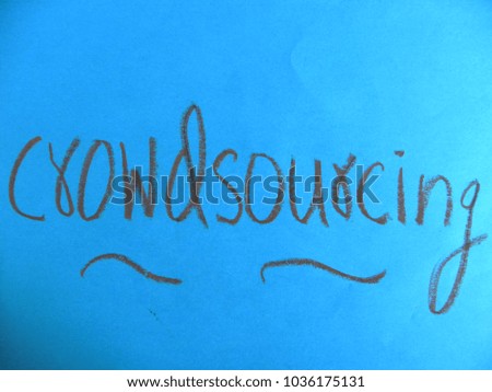 Text Crowdsourcing hand written by brown oil pastel on blue color paper