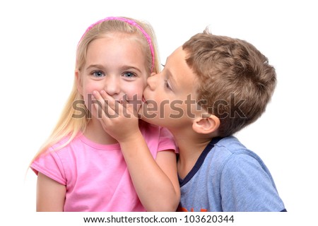 little boy kissing girl white background