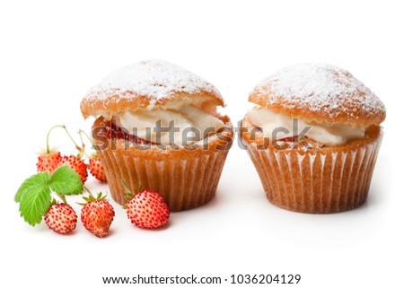 Cupcakes  stuffed with white cream and wild strawberry isolated on white 