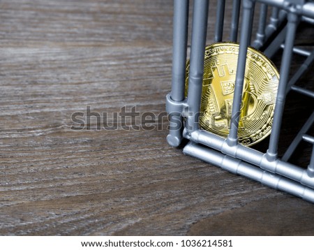 The coin is in the gray nick color put on a wooden table. The concept of investment and fluctuation of bitcoin and cryptocurrency.