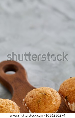 Top view close-up picture of tasty muffins on the cutting board, shallow depth of field, selective focus
