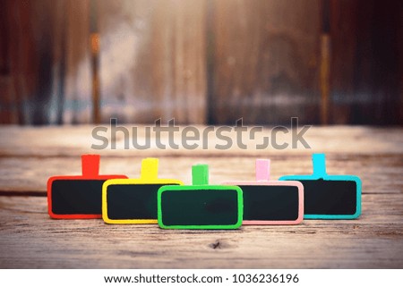 colorful wood clip notes on wooden background