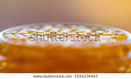 Red or yellow caviar in a glass jar closeup.