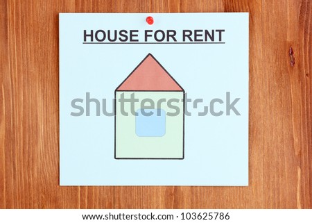 poster about renting the house on wooden background