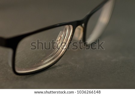 Macro photograph of the optical lens of  black frame glasses 