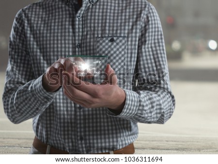 Digital composite of man holding glass interface