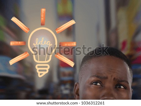 Digital composite of man looking up at light bulb