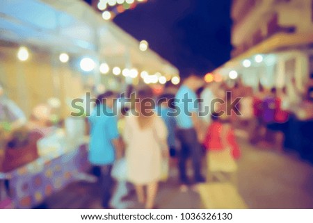 Vintage tone blurred defocused night of walking street festival in thailand bokeh background