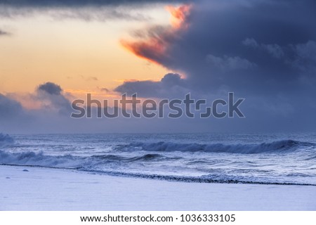 Snowy sunrise on the beach in Iceland