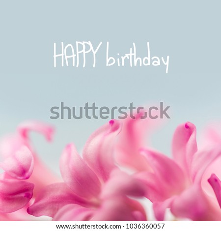 Post card with spring garden flowers and card with words Happy Birthday on it